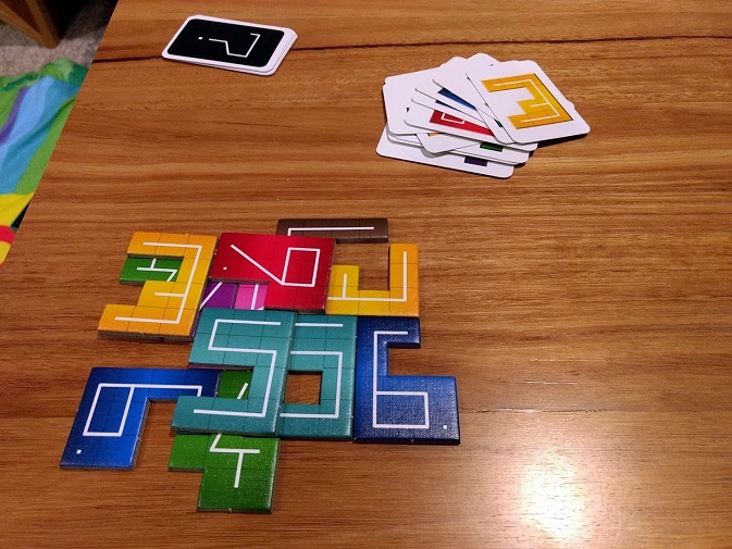 NMBR 9 game in progress, numbered polynomial tiles placed on top of one another.