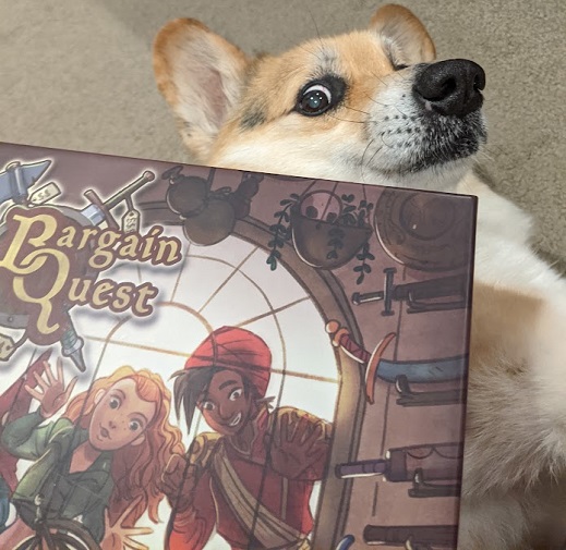 The Bargain Quest box on top of a very confused corgi.