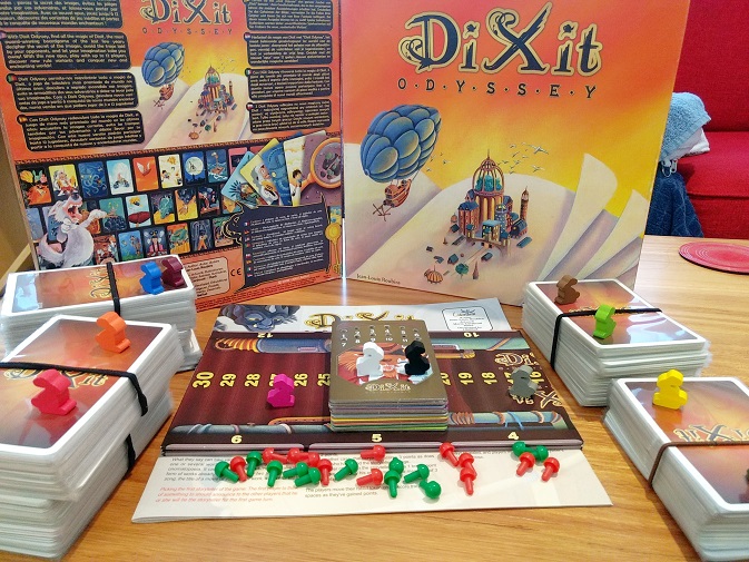 Dixit Odyssey components, plus some expansions. Lots of cards, bunny meeples, and pegs.