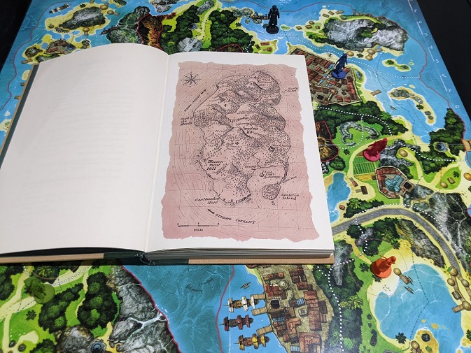 The map from Treasure Island the book, next to the map from Treasure Island the board game.