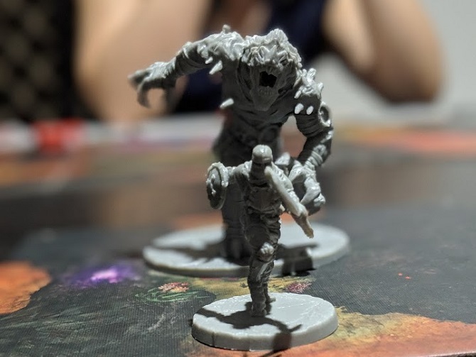 A single adventurer running towards the camera. A boss monster chasing with mouth open, barring teeth.