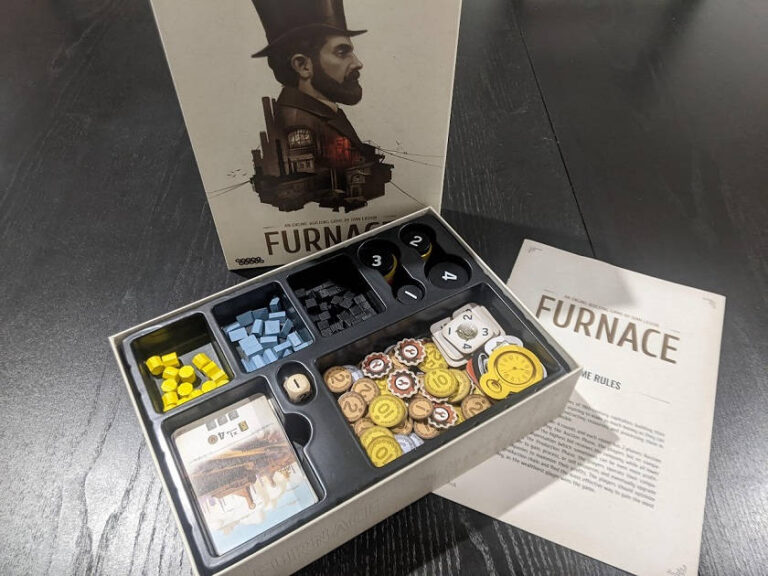 furnace box opened showing the game's insert full of components