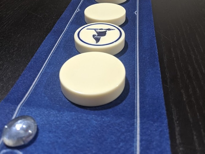 Four stones in the middle of the table, three of them turned over.