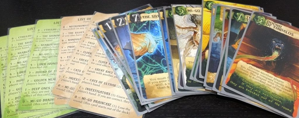 Card art, showing both the normal and insane cards, and player aids.