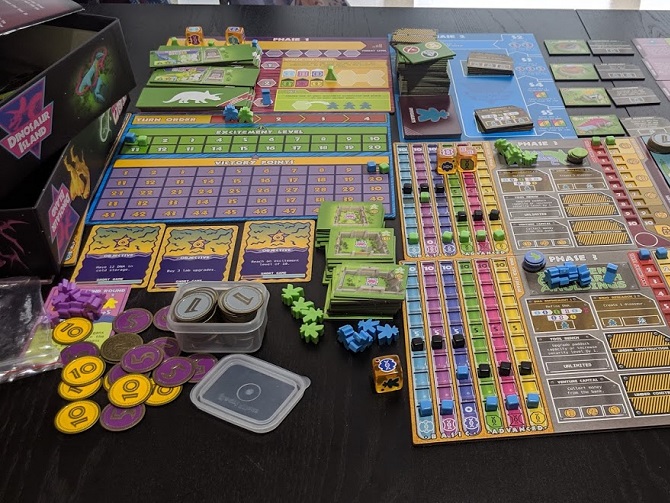 An upclose of player boards, metal coins, score board, and objective cards.
