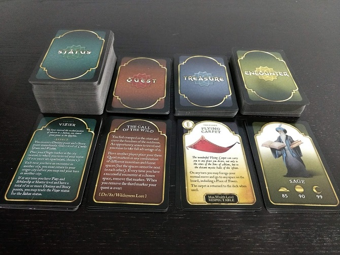 The status, quest, treasure, and encounter decks in the board game Tales of the Arabian Nights