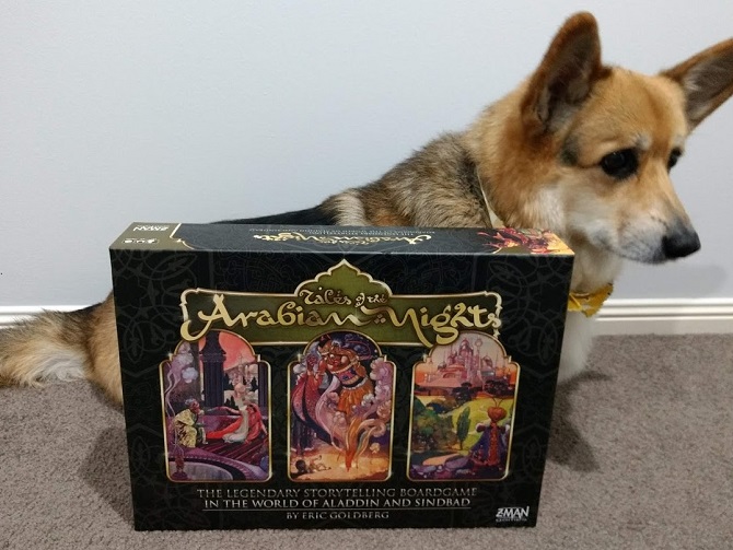Chester the corgi sitting beside the Tales of the Arabian Nights box. They're almost equal length!