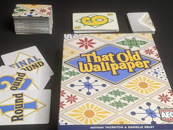 That Old Wallpaper box and components: Three round cards, 10 player cards for each player, a stack of wallpaper cards, and a smaller deck of Hazy Memory cards.