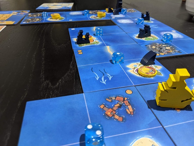 A long winding map of ocean tiles, with a couple of ships, and patrol tokens in the way.