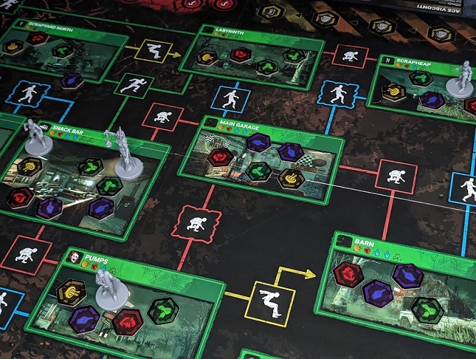 Setup for a game of Dead By Daylight: The Board Game. The Killer, Plague, starting next to an unlucky survivor.