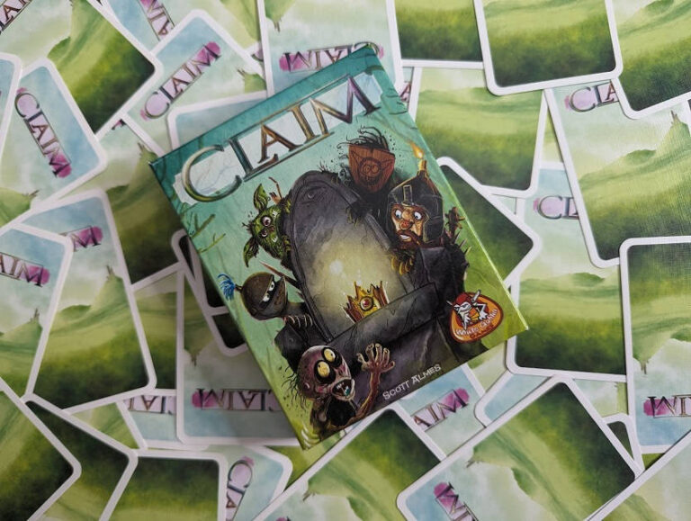 claim game box on top of scattered cards
