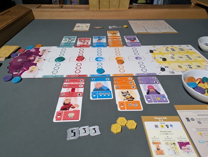 A full gameplay setup of the Zenith board game on a table, displaying the central planets board, character cards, player aids, and token bowls during a session.