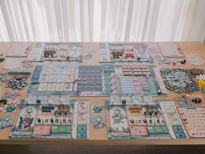 A complete table setup of the board game Rosalie. A long main game board filled with floral cards, track lanes, and garden spaces sits in the center, flanked by four dual-layer player boards with character art, wooden meeples, screen-printed tokens, and resource piles spread across the light wood table.
