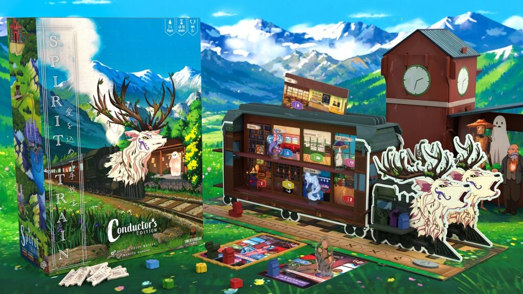 The product box for Spirit Train: Conductor's Edition stands beside an assembled 3D train model set against an illustrated mountain backdrop. A red clocktower structure, character standees, small train-shaped markers, custom wooden tokens, and train tickets are displayed across the lush green play area.